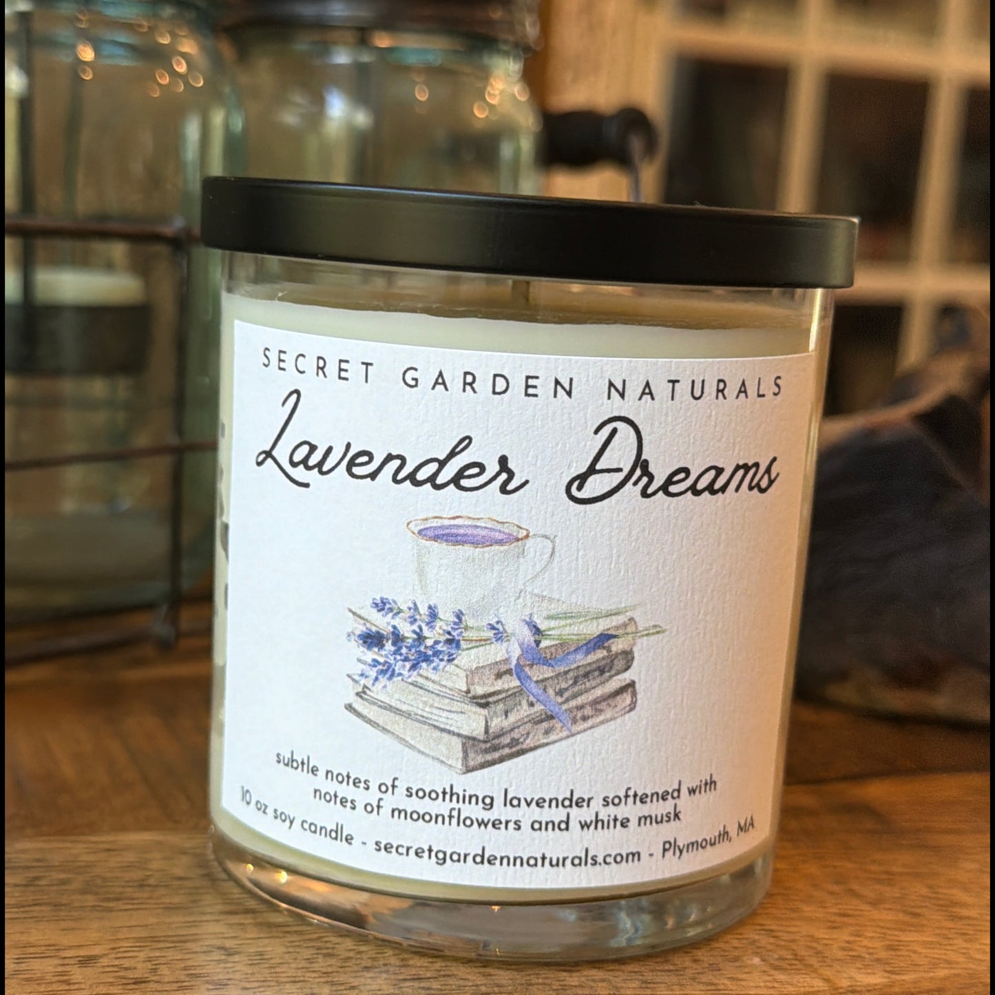 Lavender Dreams 10 oz candle in glass jar on a wooden surface