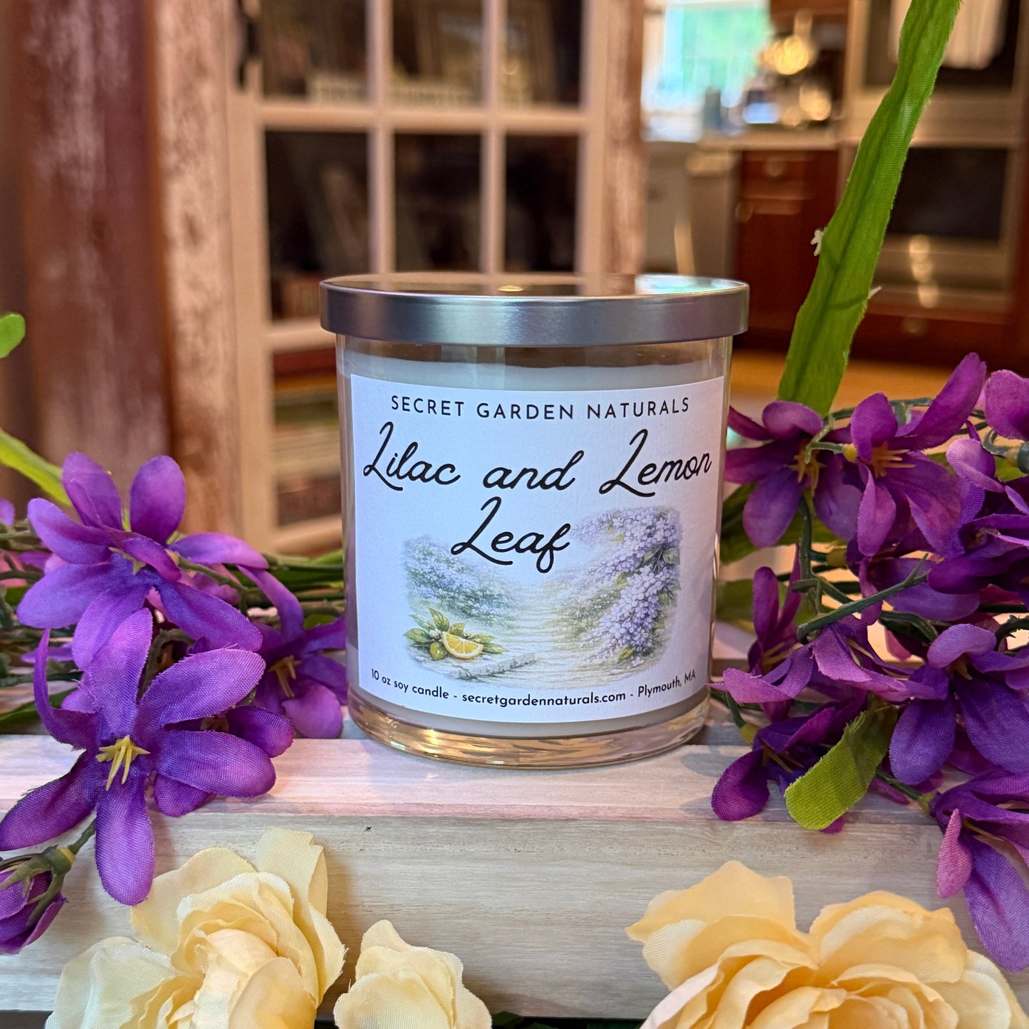 Canister labeled 'Lilac and Lemon Leaf' with purple and yellow flowers on a wooden surface.
