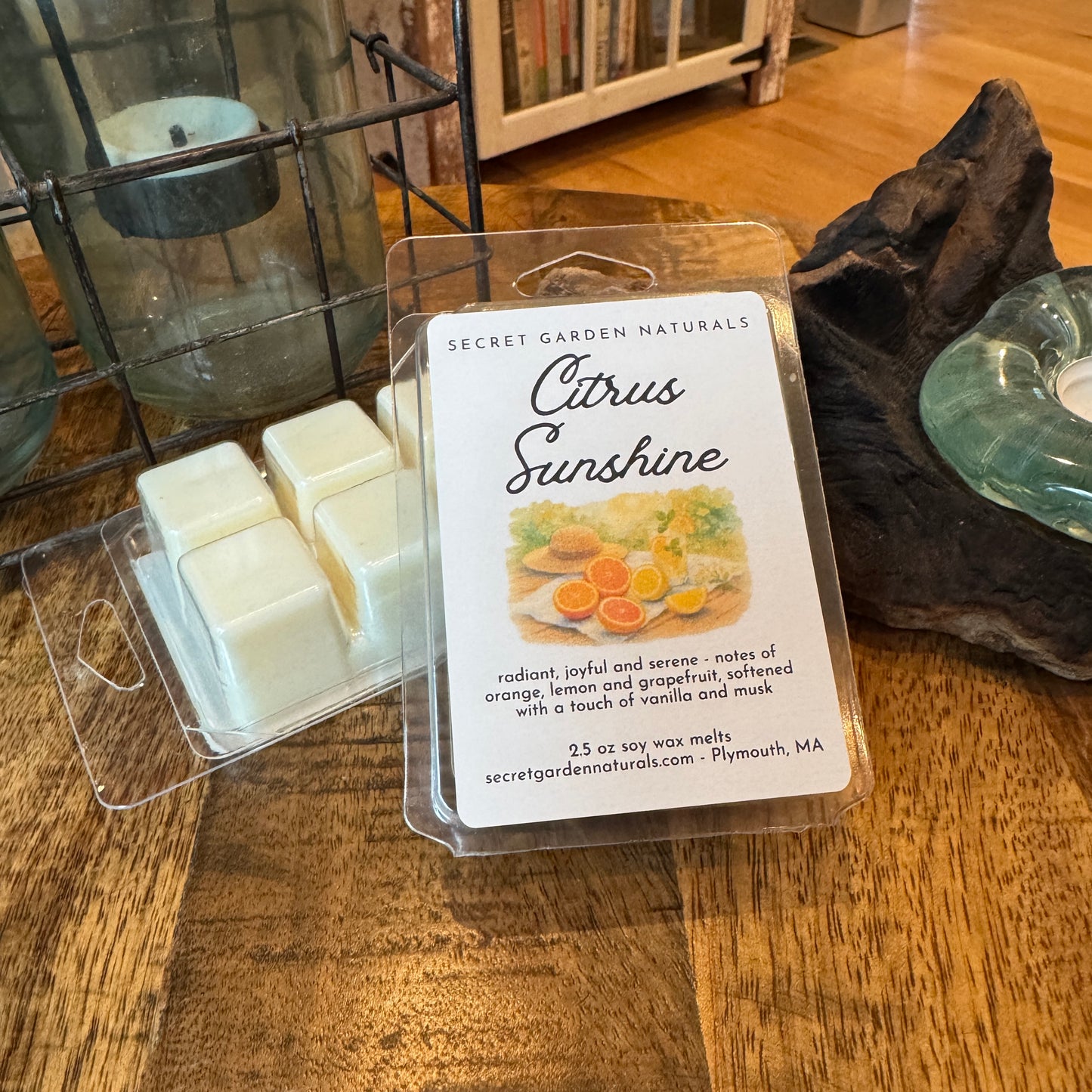 A package of Citrus Sunshine wax melts, on a wooden table.