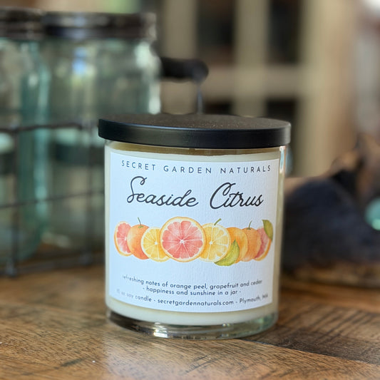Seaside Citrus glass jar 10 oz candle on a wooden surface.