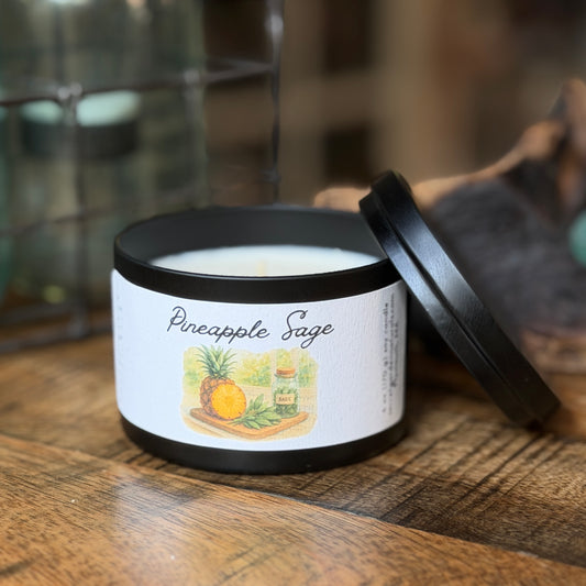 Pineapple sage, 6 oz candle tin on a wooden surface.