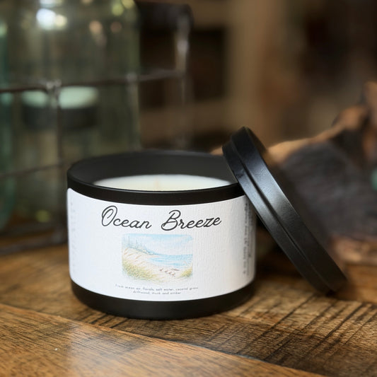 Ocean Breeze candle tin on a wooden table.