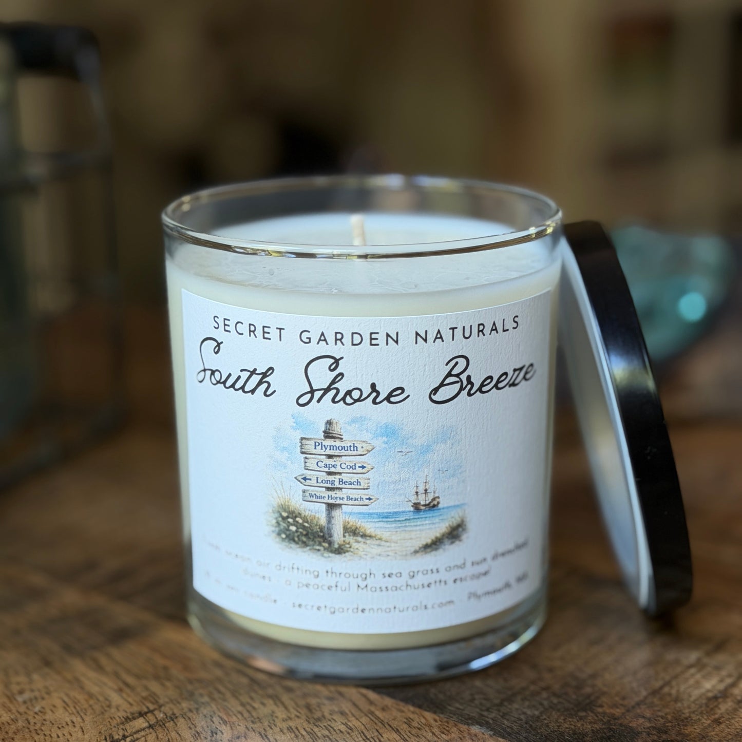 Secret Garden Naturals South Shore Breeze candle on a wooden surface.