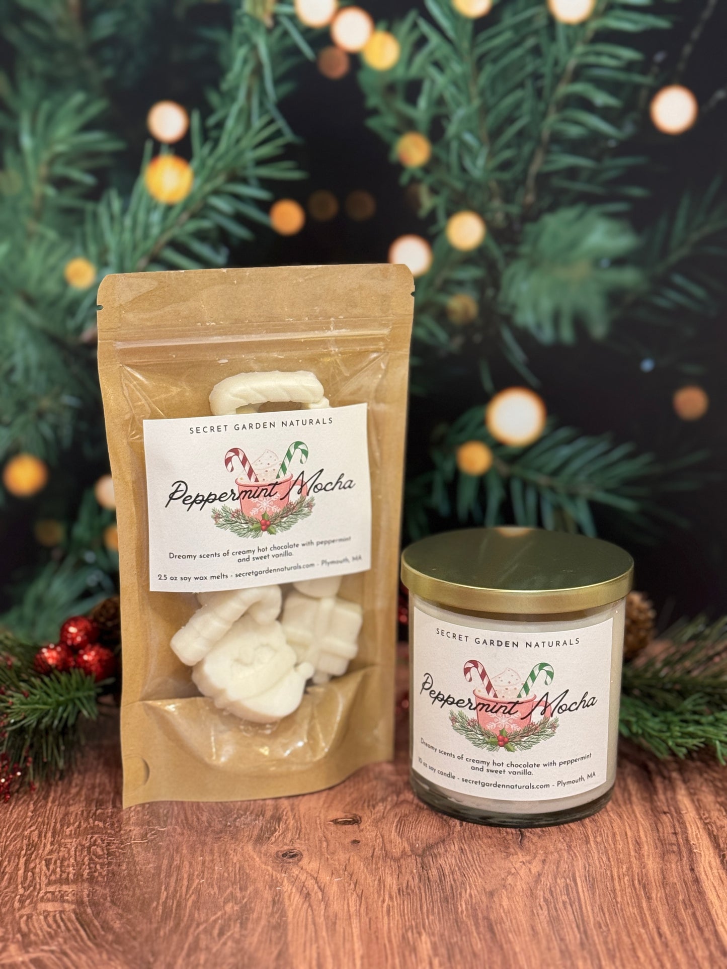 Peppermint Mocha product packaging with a candle and packaging on a wooden surface with Christmas decorations.