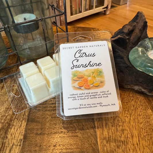 A package of Citrus Sunshine wax melts, on a wooden table.