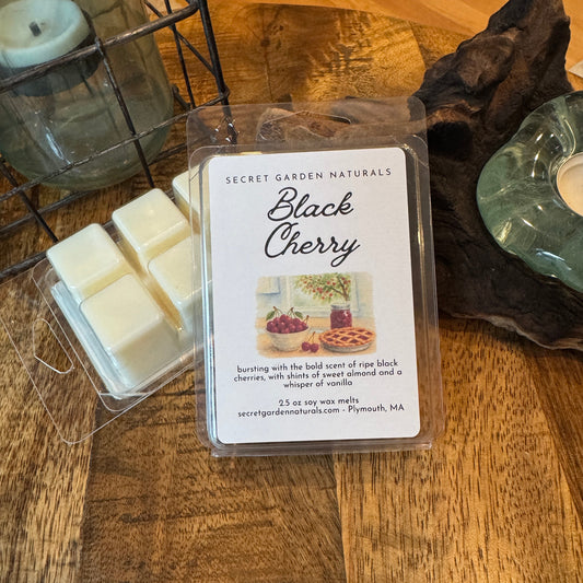 Packaged wax melts labeled 'Black Cherry' on a wooden surface