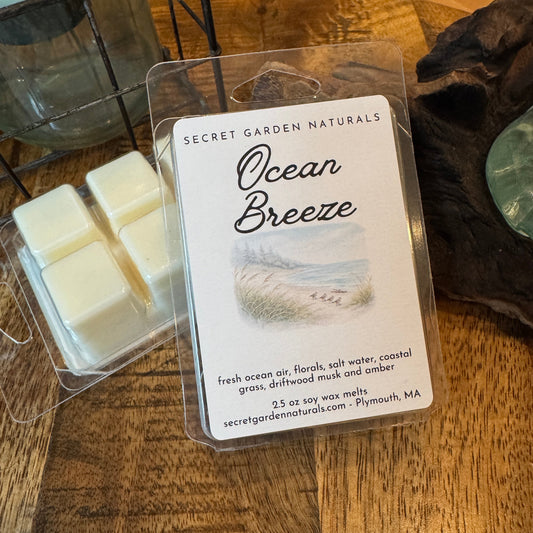 Packaged wax melts labeled 'Ocean Breeze' on a wooden surface