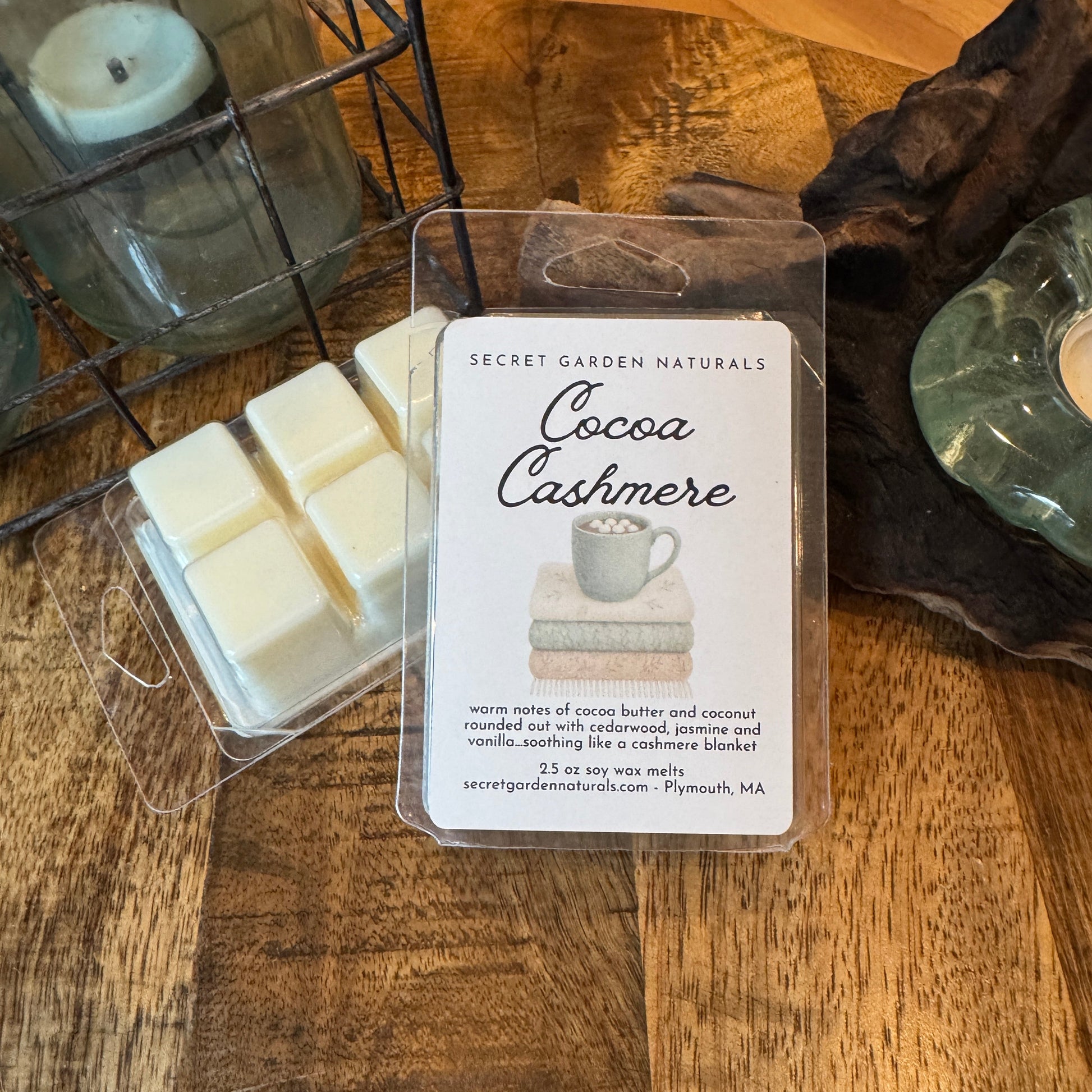 Cocoa Cashmere wax melts in packaging on a wooden surface