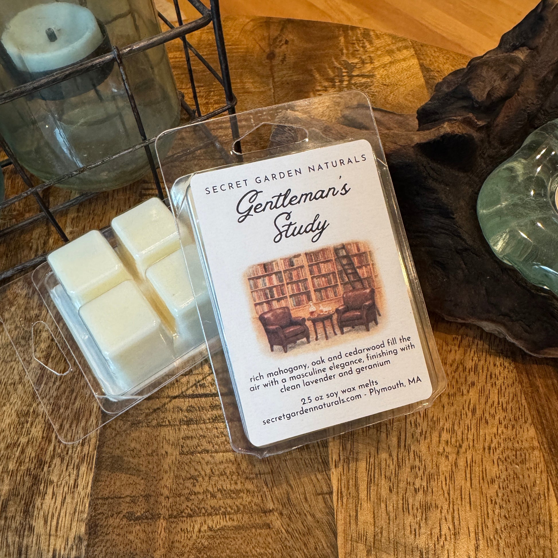 Packages of Gentleman's study wax melts on a wooden table 