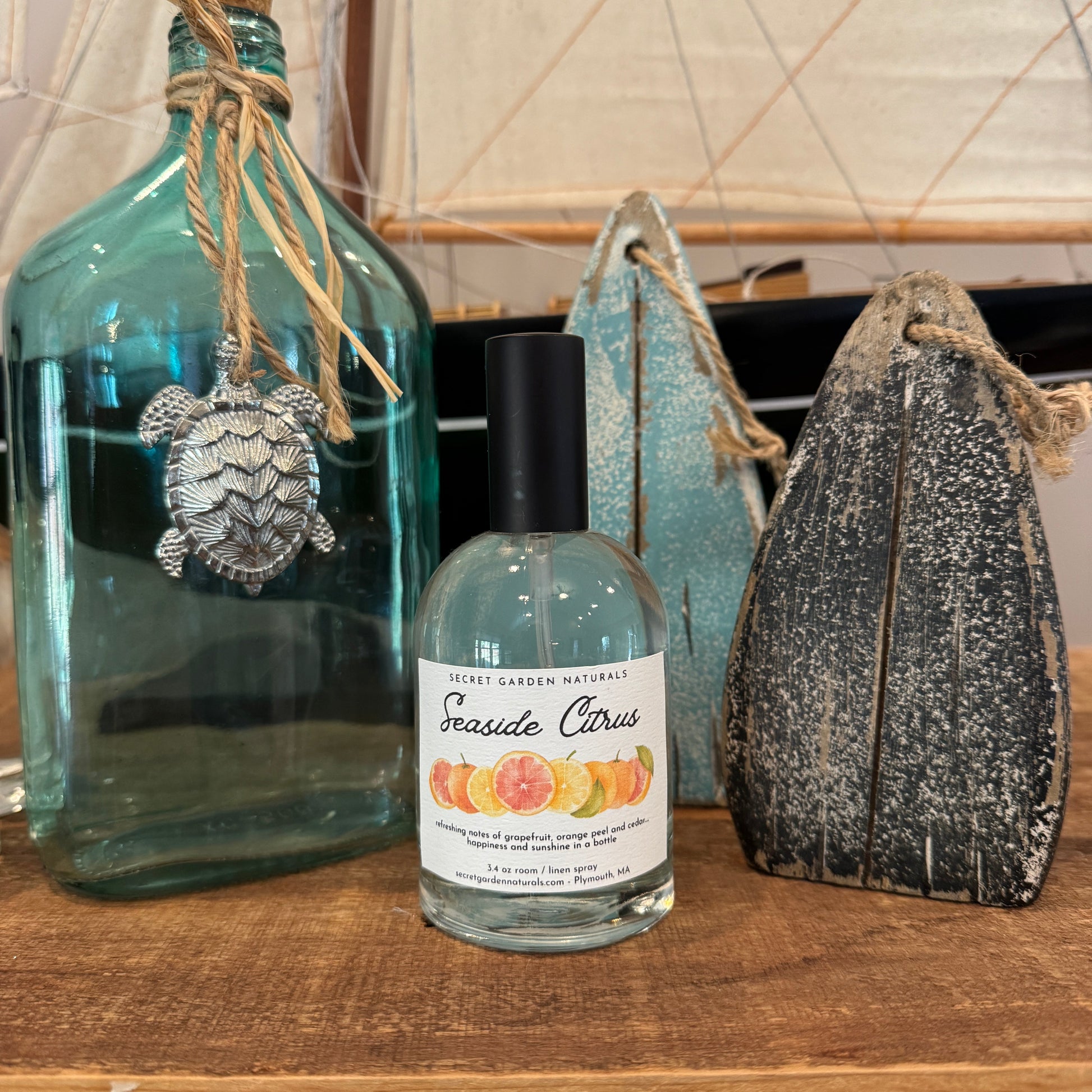 Bottle of Seaside Citrus room/linen spray on wooden table with nautical decor 